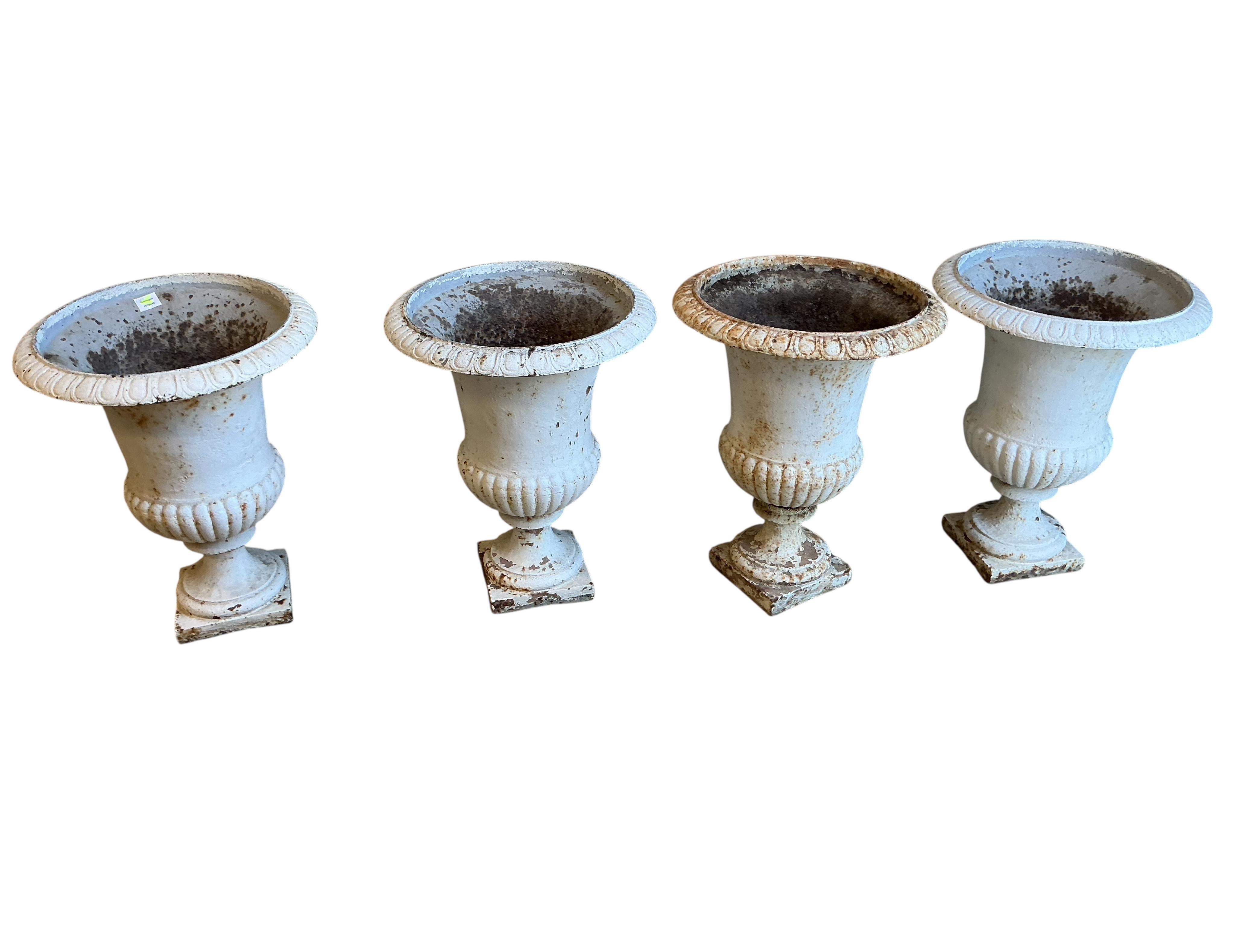 Four Victorian white painted cast iron campana garden urns, diameter 50cm, height 64cm